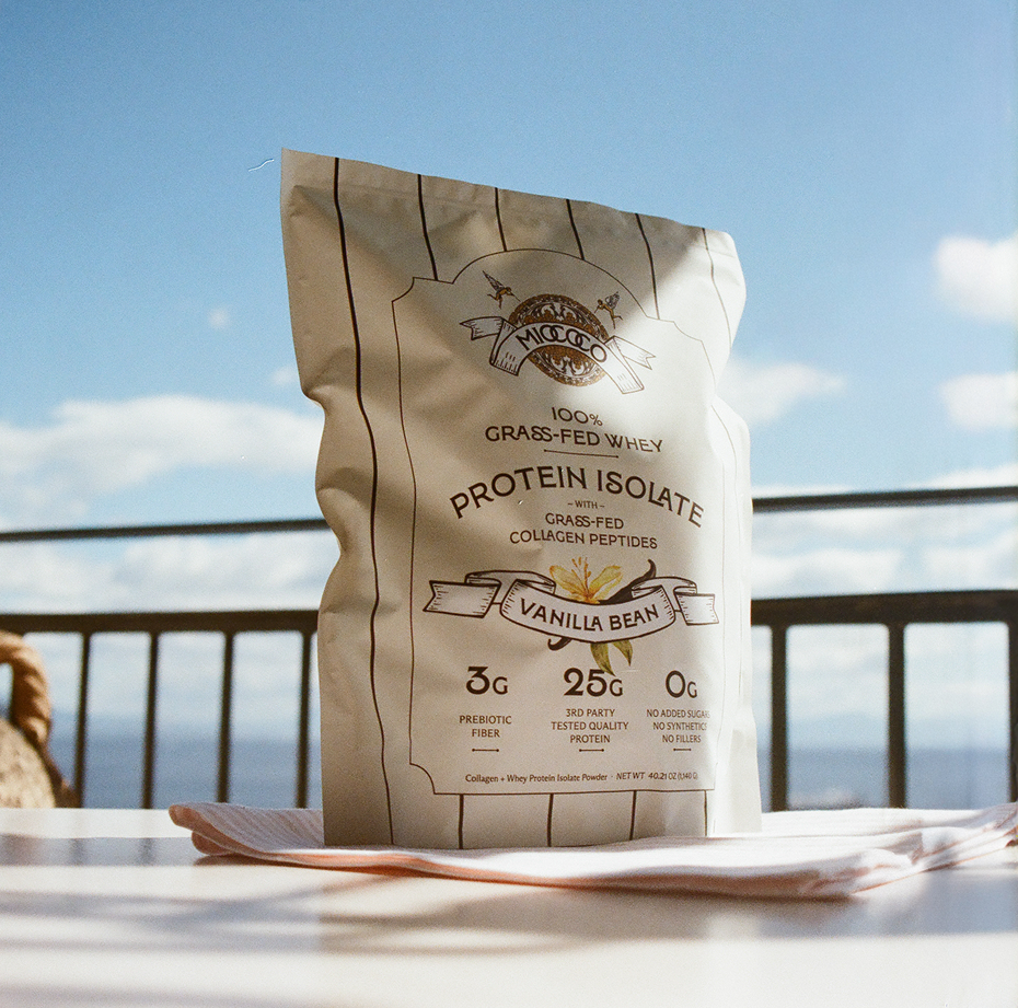 Protein isolate package with vanilla bean flavor on a table with a scenic background