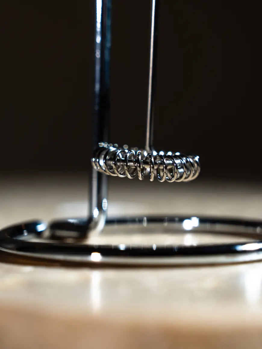 Close up shot of an electric hand blender whisk attachment. 