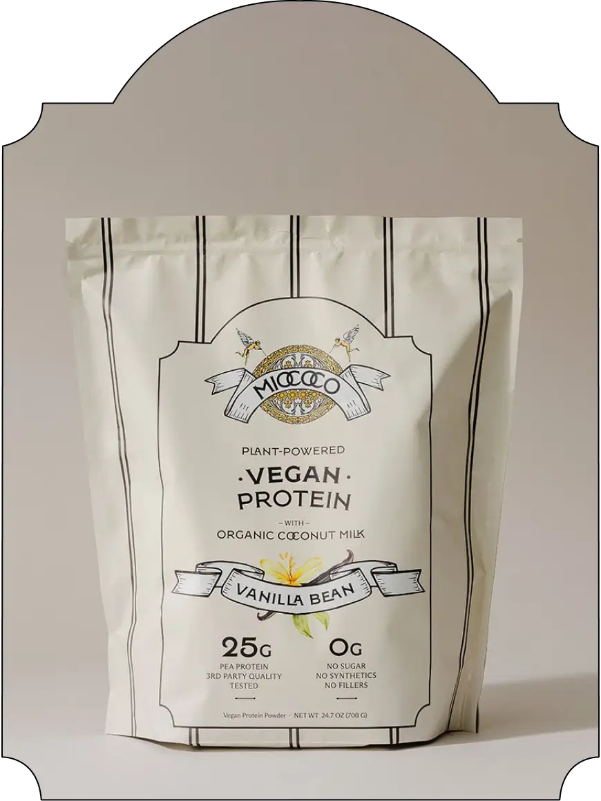A stand-up pouch of Micococo Vegan Protein with Organic Coconut Milk in Vanilla Bean flavor, shown against a neutral beige background with a decorative arch frame.